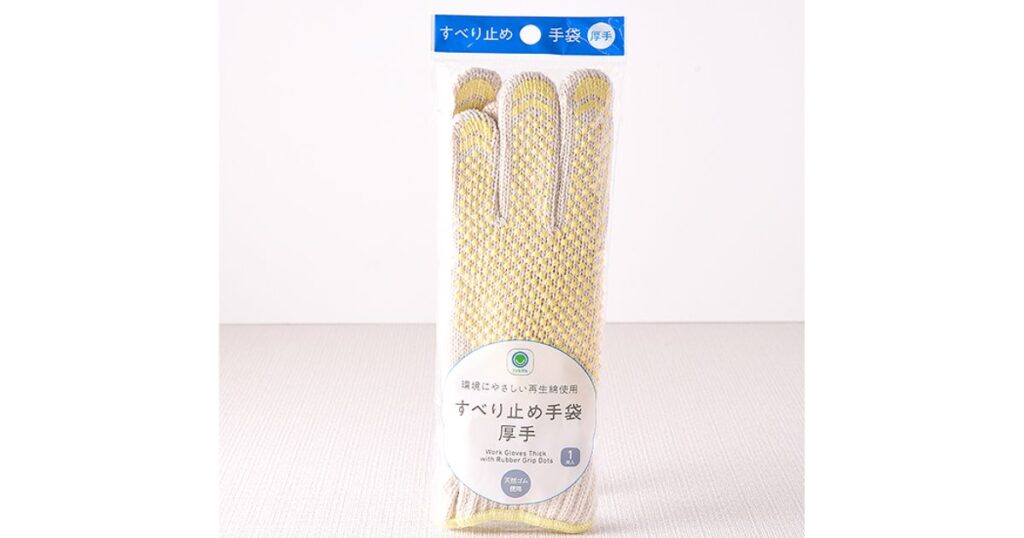 透明なパッケージに入った、黄色の滑り止め付き厚手軍手の画像。