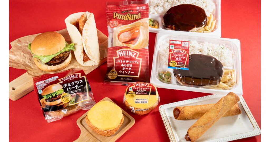 ファミリーマートとハインツ（HEINZ）のコラボ商品の集合写真。デミグラスハンバーグ弁当、オムライス、バーガーなどの商品が赤い背景の上に並べられている。