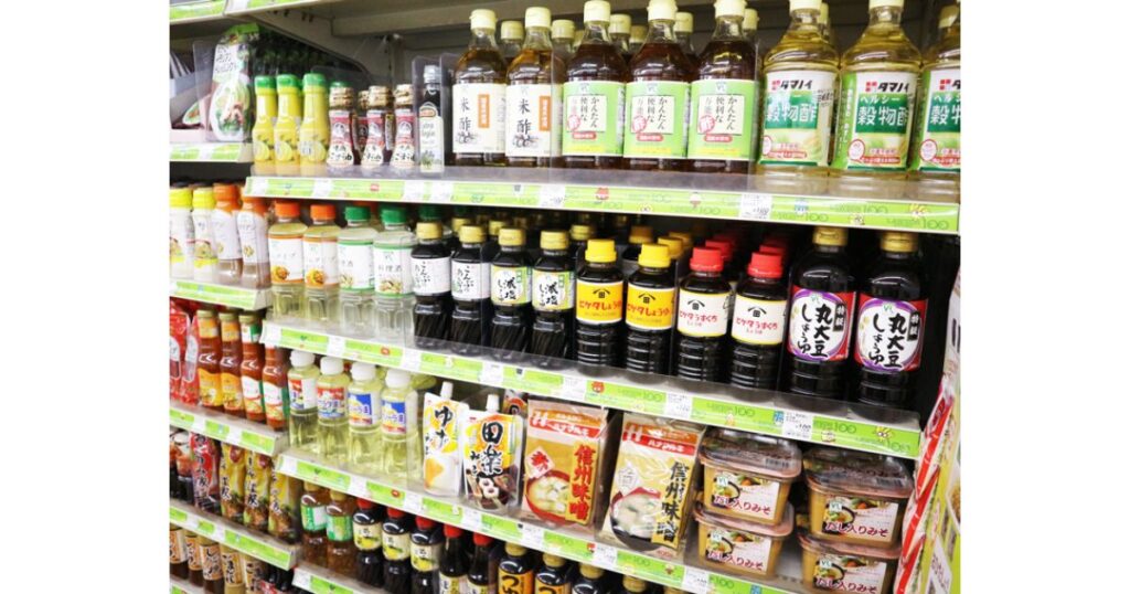 コンビニの調味料コーナーの棚に陳列されている、様々な種類の生味噌パックや醤油、お酢などの写真