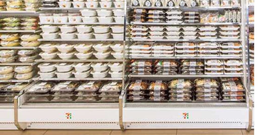セブン-イレブンの店内に綺麗に陳列された、お弁当やお惣菜が並ぶ冷蔵棚の様子